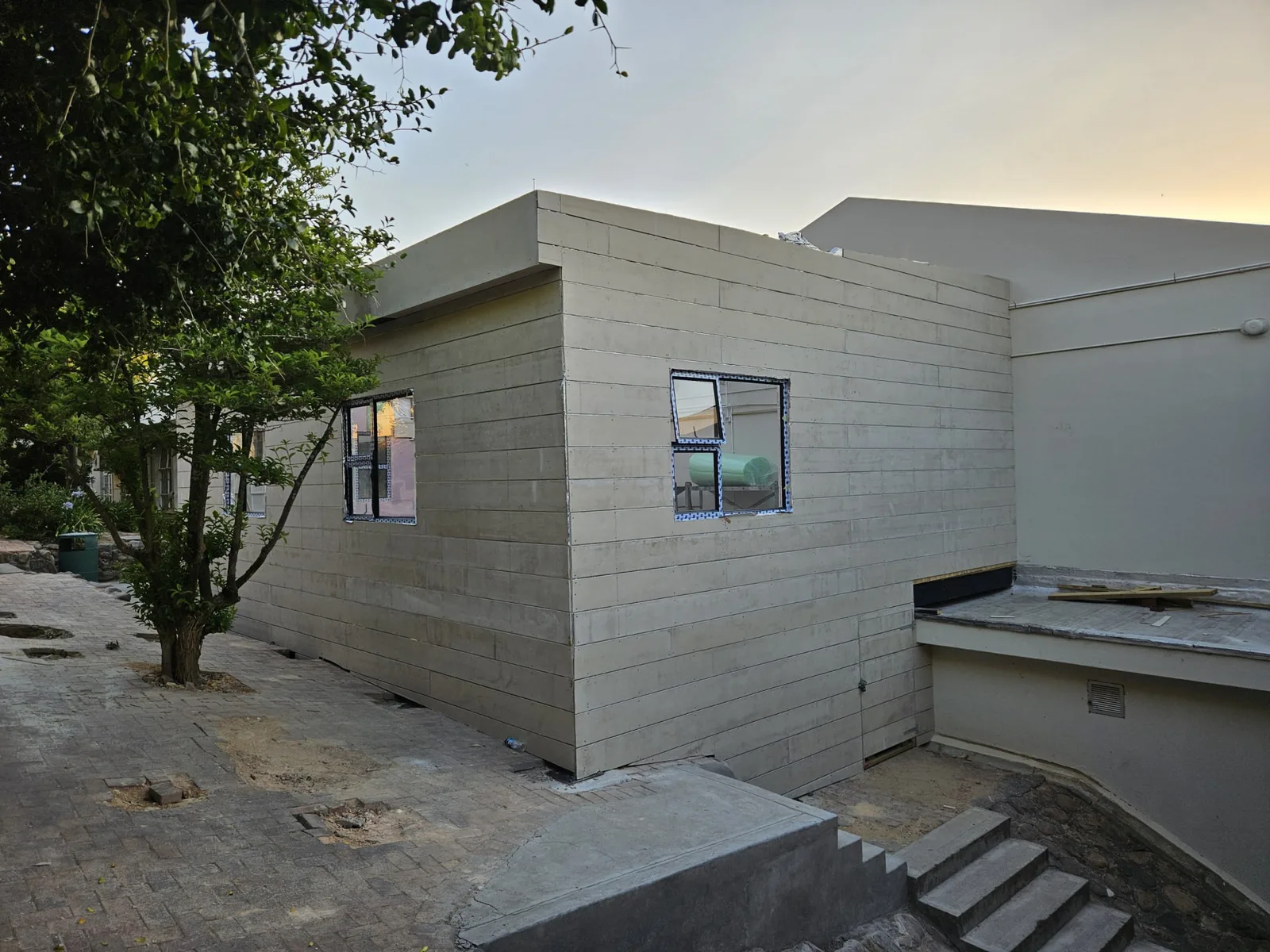 Fibre-cement cladding installed on the art classroom shell before painting