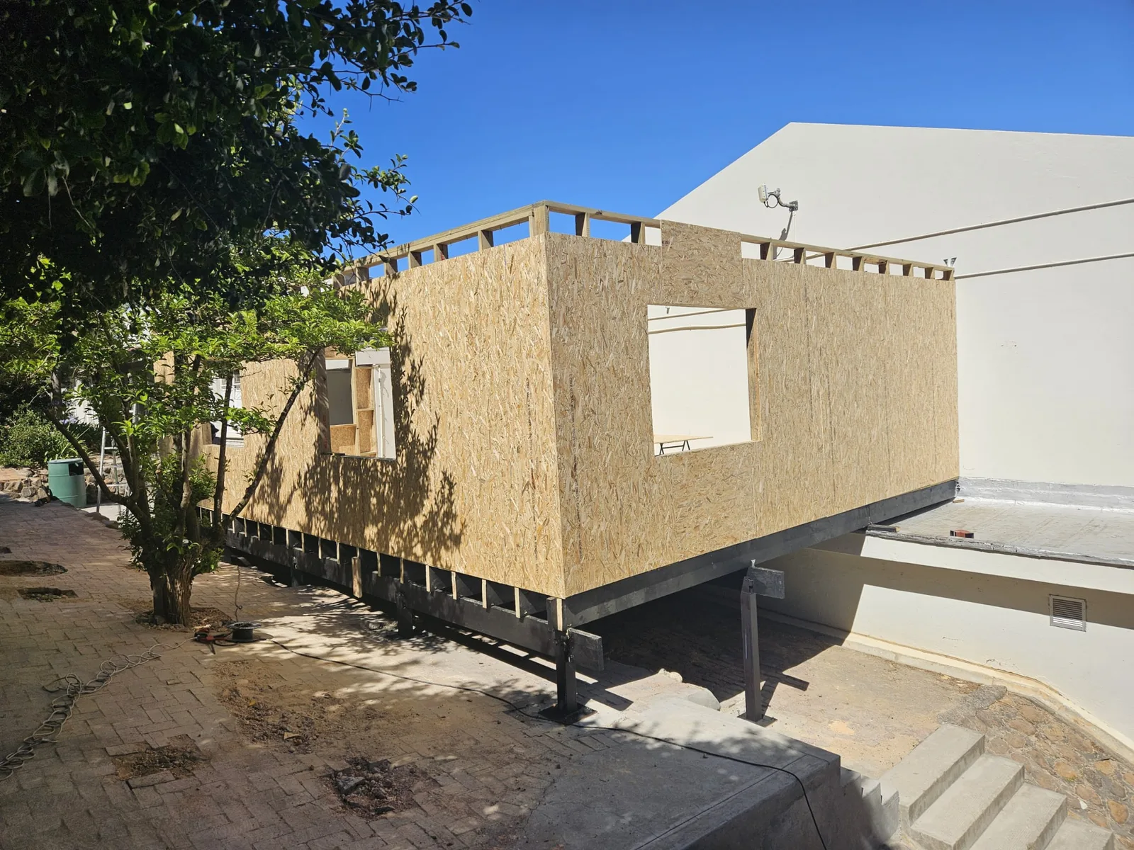OSB sheathing fixed to the timber frame walls on the raised steel base