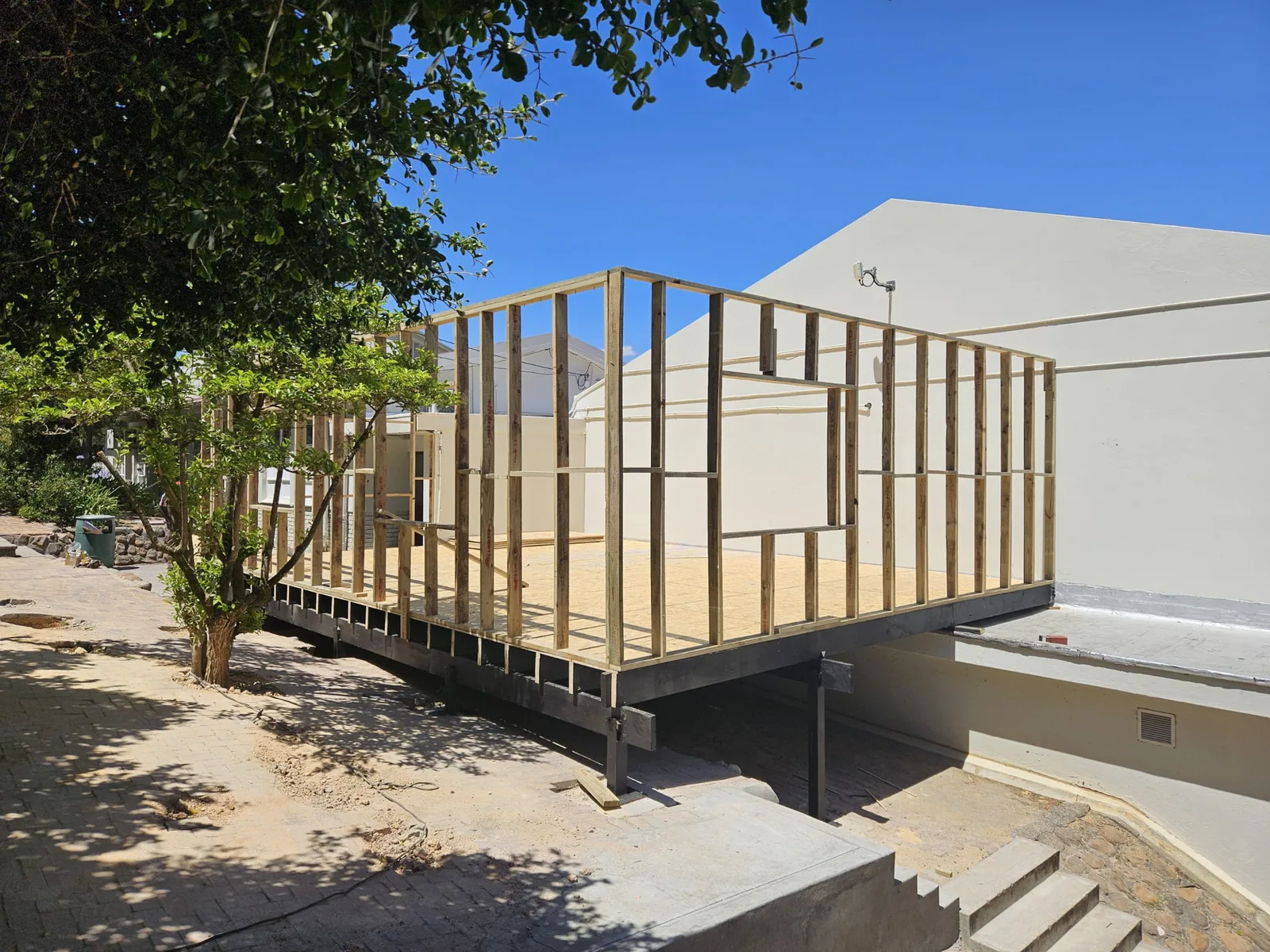 Timber wall framing erected on the steel sub-frame and elevated platform