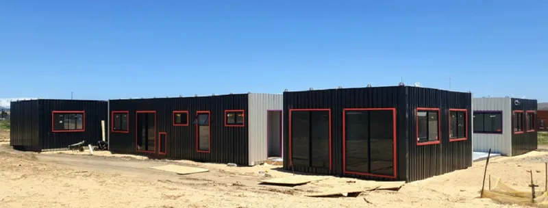 Modules positioned on site with window openings framed, ahead of roof installation