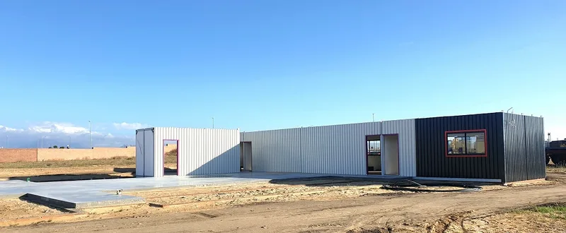 Early stage of the build with the first modules placed on the concrete slab