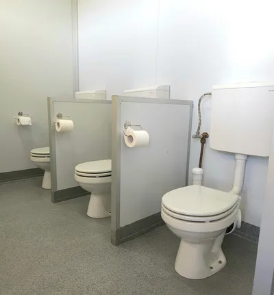 Children's ablution block with low-level toilets and partition screens