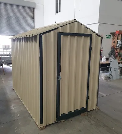 Completed garden shed in the workshop before delivery, showing the lockable door and apex roof