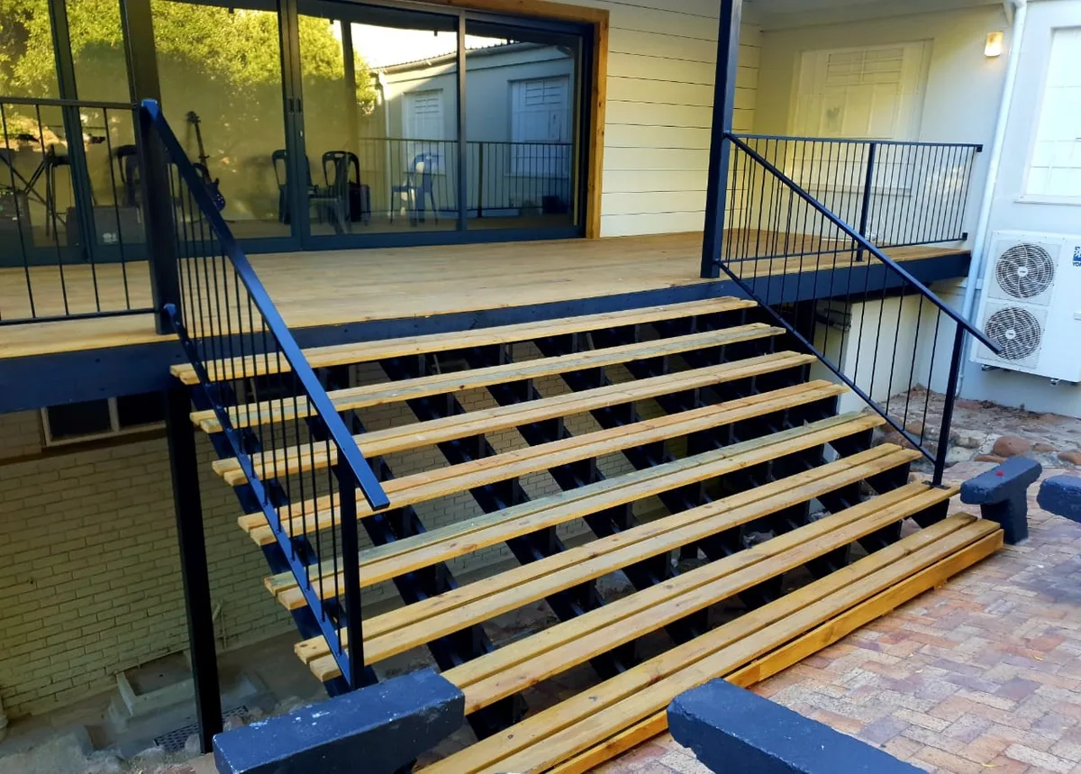 Timber and steel entrance stairs leading up to the music room deck