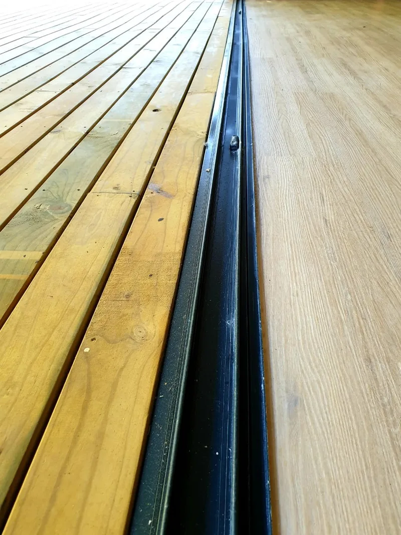 Detail of the sliding door track where the outdoor deck meets the internal floor
